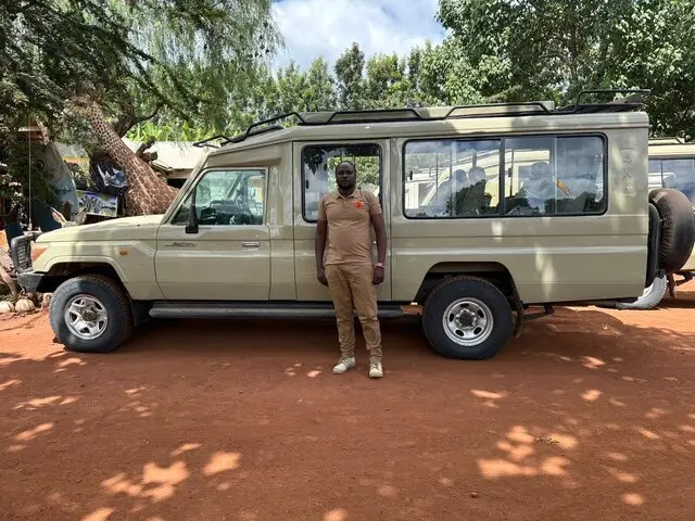 Photo of a local safari guide in his jeep